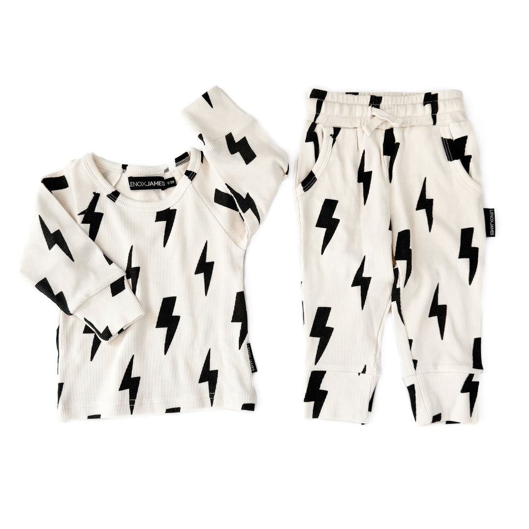 White outfit with black lightning bolt patterns on a white background