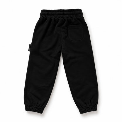 Back view of LENOX JAMES kids joggers in black, showing the rear patch pocket, elastic waistband and gathered cuffs.