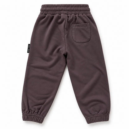 Back view of LENOX JAMES kids joggers in smoky purple-gray, showing the rear patch pocket, elastic waistband and gathered cuffs.