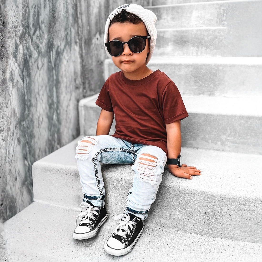 Child wearing LENOX JAMES light wash distressed jeans with a rust basic tee