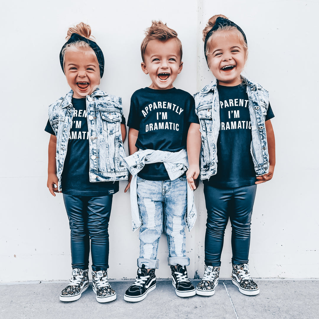 Three children wearing matching outfits with text on a white background