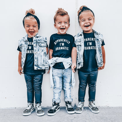 Three children wearing matching outfits with text on a white background