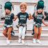 Three children wearing matching &