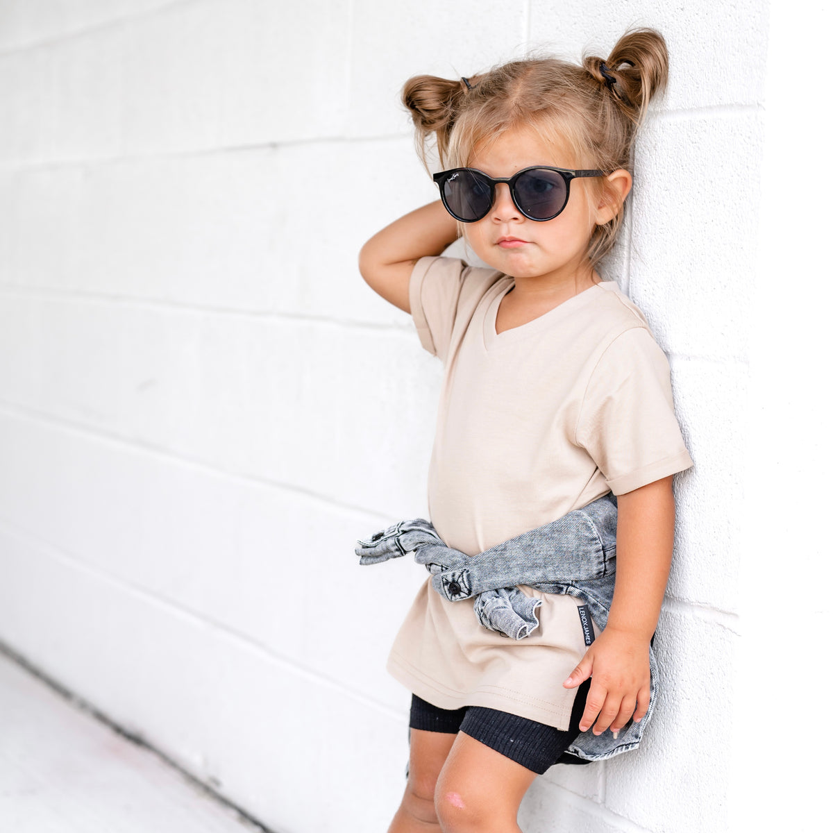 Toddler girl wearing a LENOX JAMES coffee brown V-neck tee with casual bottoms