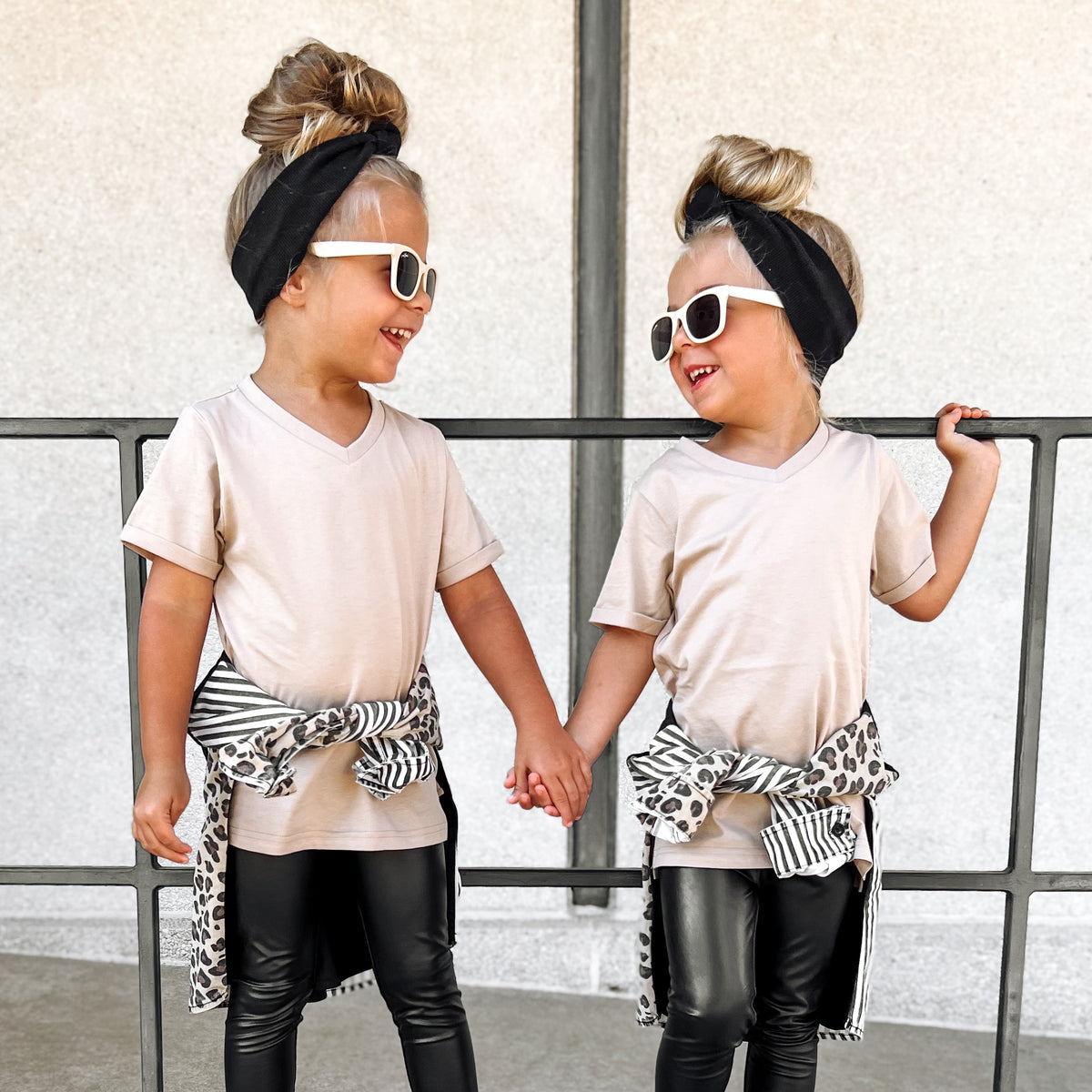 Twin girls wearing a LENOX JAMES coffee brown V-neck tee with casual bottoms