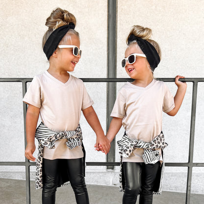 Twin girls wearing a LENOX JAMES coffee brown V-neck tee with casual bottoms